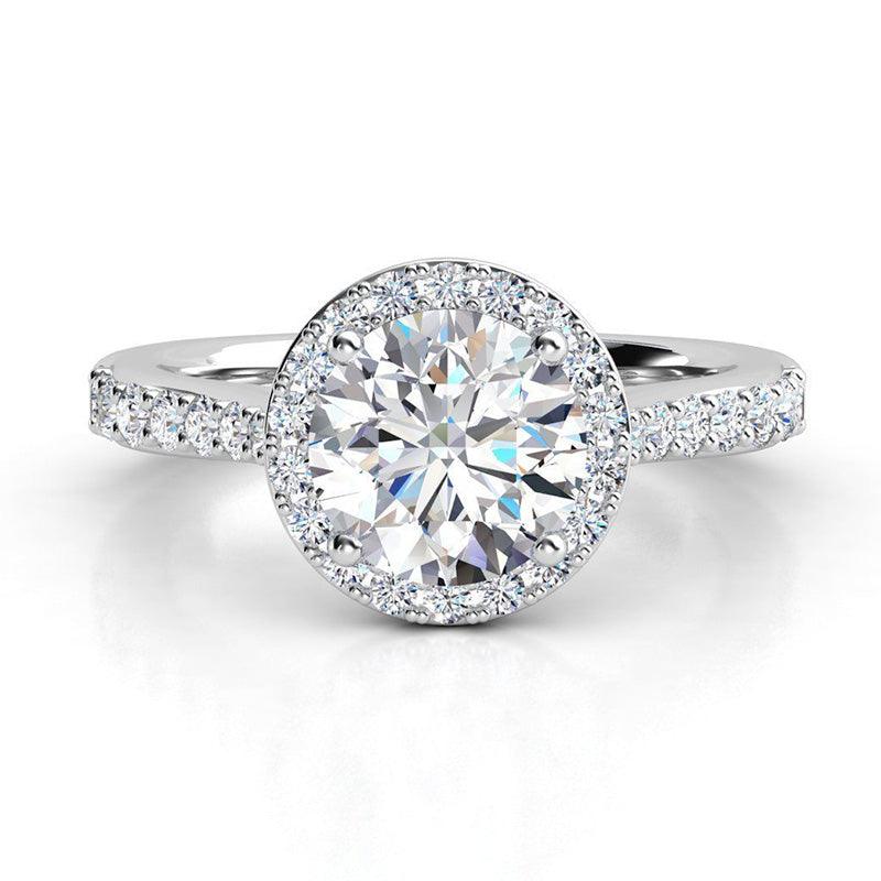 Victoria in Platinum - round diamond halo engagement ring with diamonds on the band and under the main diamond.