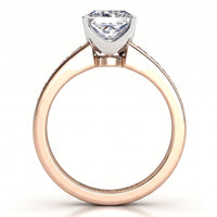 A rose gold solitaire engagement ring with a square shaped diamond in a silver-colored setting, shown on a clean white background.
