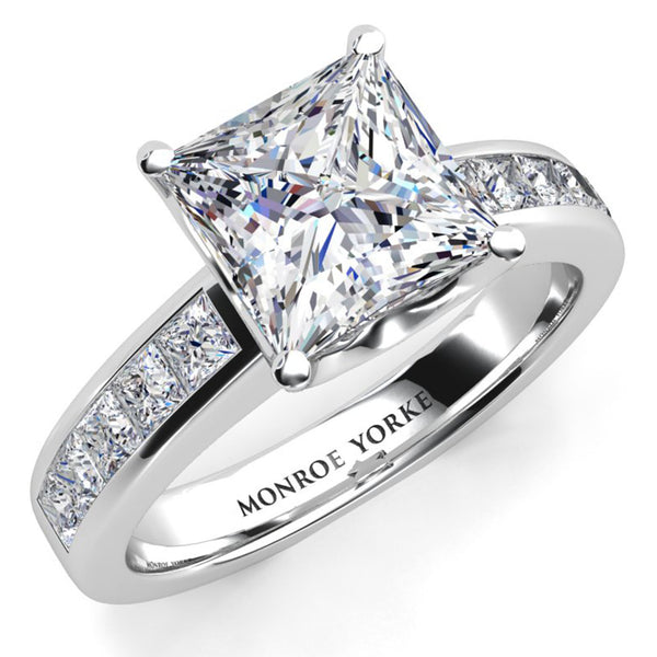 Albany - a princess-cut diamond engagement ring in a polished white gold or platinum band with channel set princess cut accent diamonds.