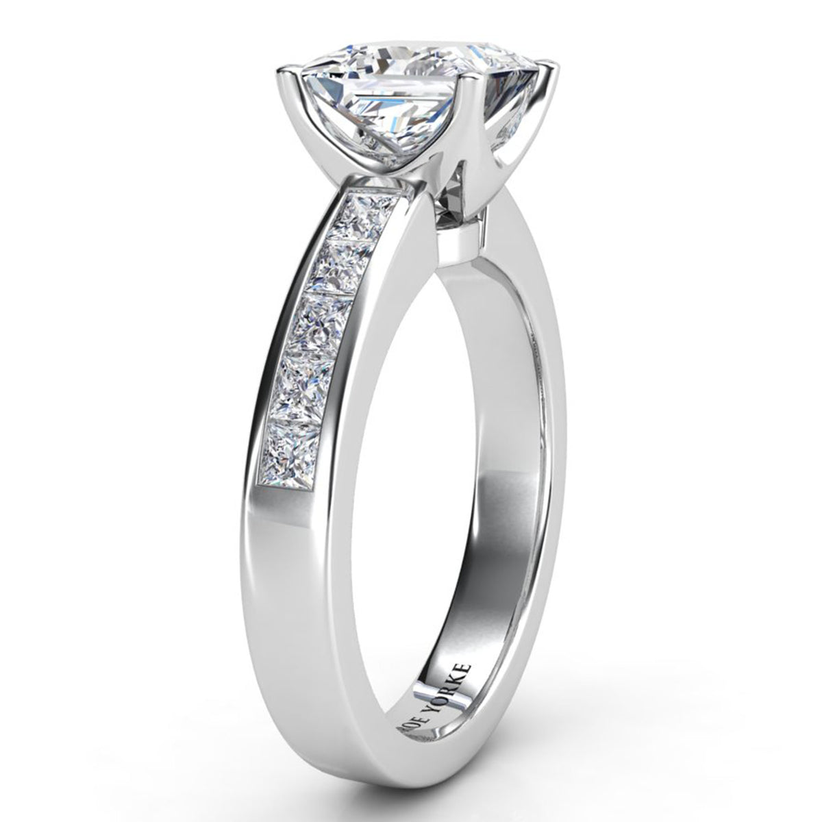 A white gold or platinum diamond ring with a large princess cut center stone and channel set diamond channel along the band, shown on a clean white background.