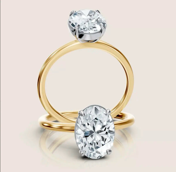 Oval cut diamond solitaire ring - Alcina.  Yellow gold band and white gold setting 