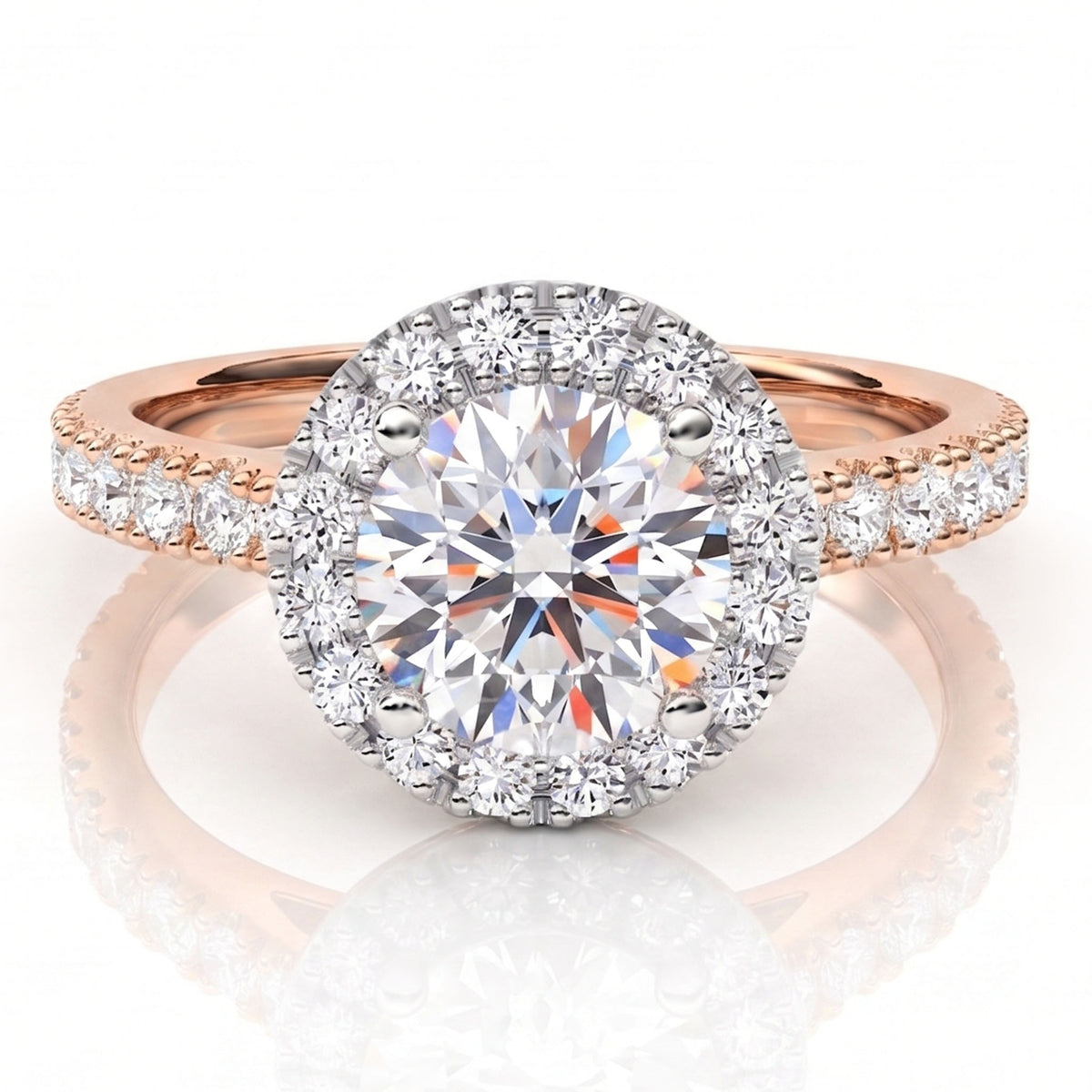 A round halo engagement ring featuring a large round-cut centre stone surrounded by a halo of smaller stones, set on a rose gold band with pavé accents, shown on a reflective white surface.
