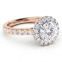 Ariana - A rose gold halo ring with a large round-cut centre stone and a row of smaller diamonds along the band, shown on a clean white background. The inside of the band is engraved with the brand name 'MONROE YORKE'.