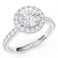 Ariana - white gold or platinum -  halo engagement ring with a large round brilliant-cut centre diamond and smaller halo diamonds, featuring a shank with pave set diamonds. 