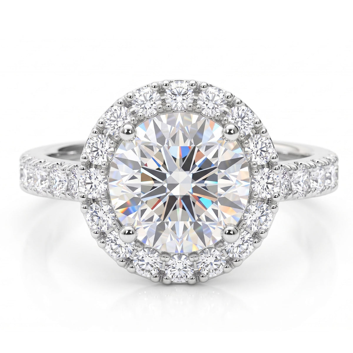 Ariana - a round-cut halo engagement ring featuring a large centre stone surrounded by a halo of smaller stones, with a pavé-set band. White gold or platinum. 