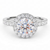 Ariana - round diamond halo ring with a round-cut centre stone and surrounding smaller diamonds on a polished white gold or platinum band, shown on a clean white background.