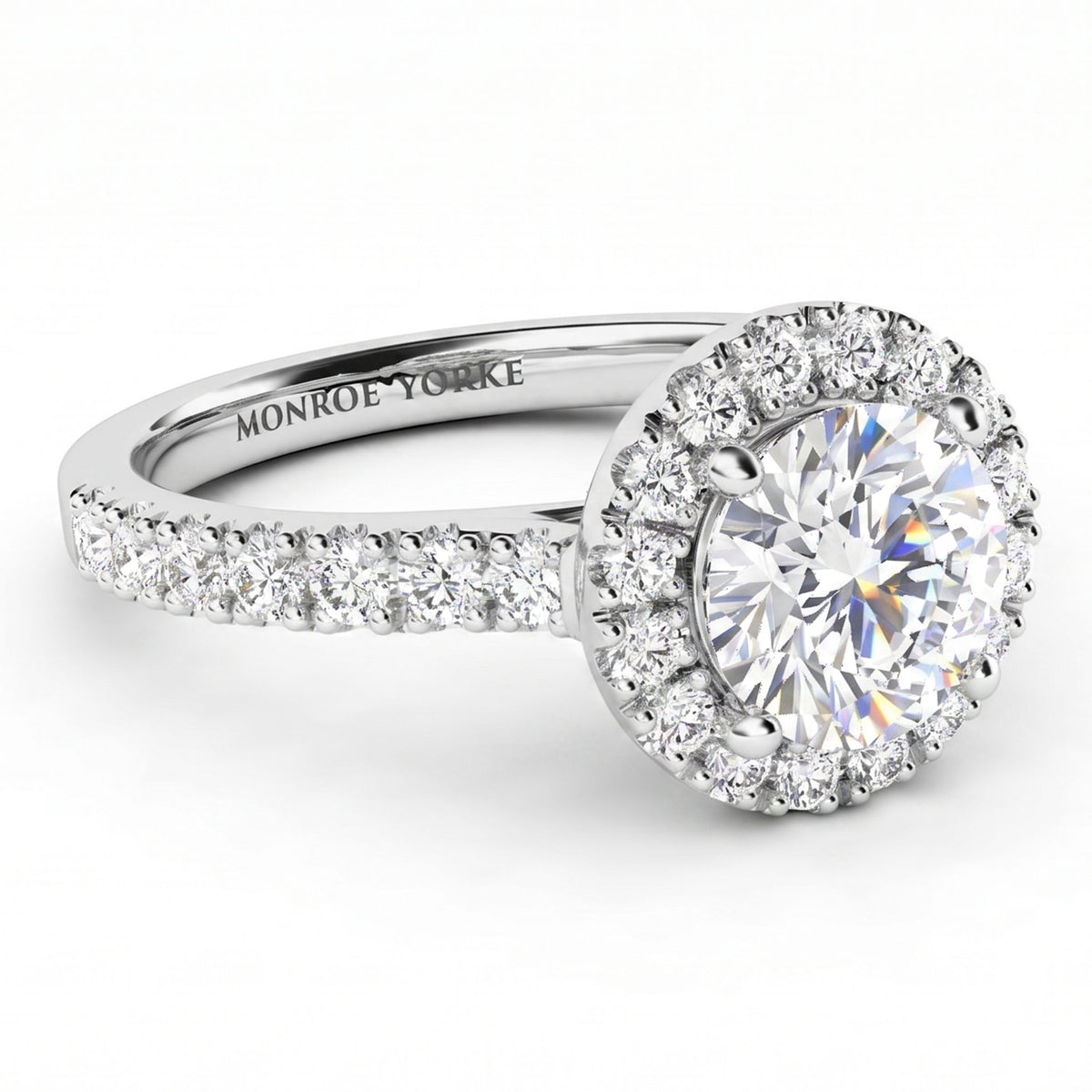 Ariana Halo diamond engagement ring -  round-cut halo engagement ring with a brilliant centre stone and a surrounding halo, set on a pavé-set shank. white gold or platinum. 