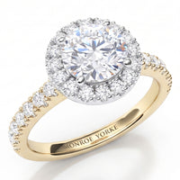 Ariana - a yellow gold  halo engagement ring featuring a round brilliant-cut centre stone surrounded by a halo of smaller diamonds, with a shank paved with small round diamonds. 