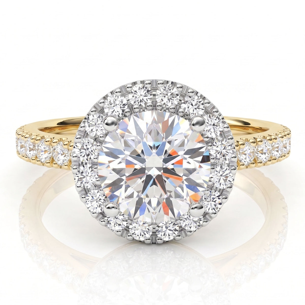 Ariana - a yellow gold halo engagement ring featuring a large round brilliant-cut centre diamond surrounded by a halo of smaller round diamonds, with the gold band adorned with pavé-set side diamonds.