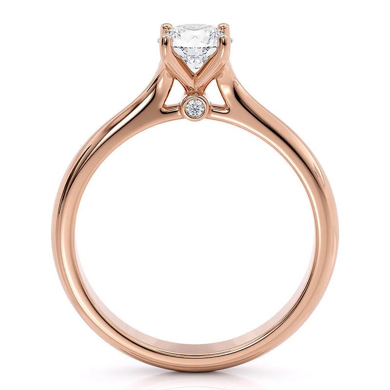 Asti rose gold solitaire engagement ring, angled view of the four claw head and polished band