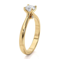 Asti yellow gold solitaire engagement ring, side view showing the bezel-set accent diamonds under the centre setting