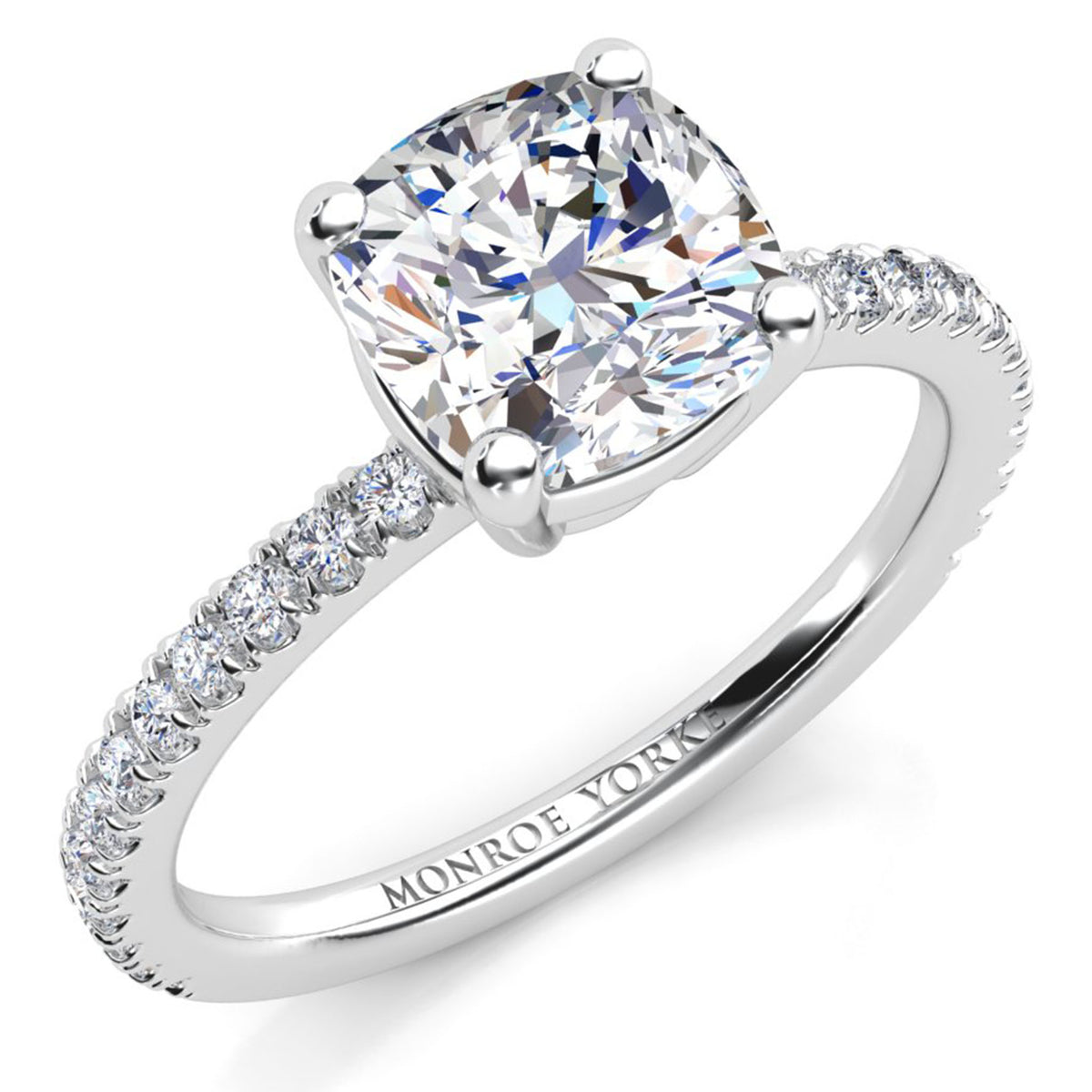 White gold or platinum  diamond engagement ring with a cushion-cut center stone and a pavé-set band  on a clean white background.