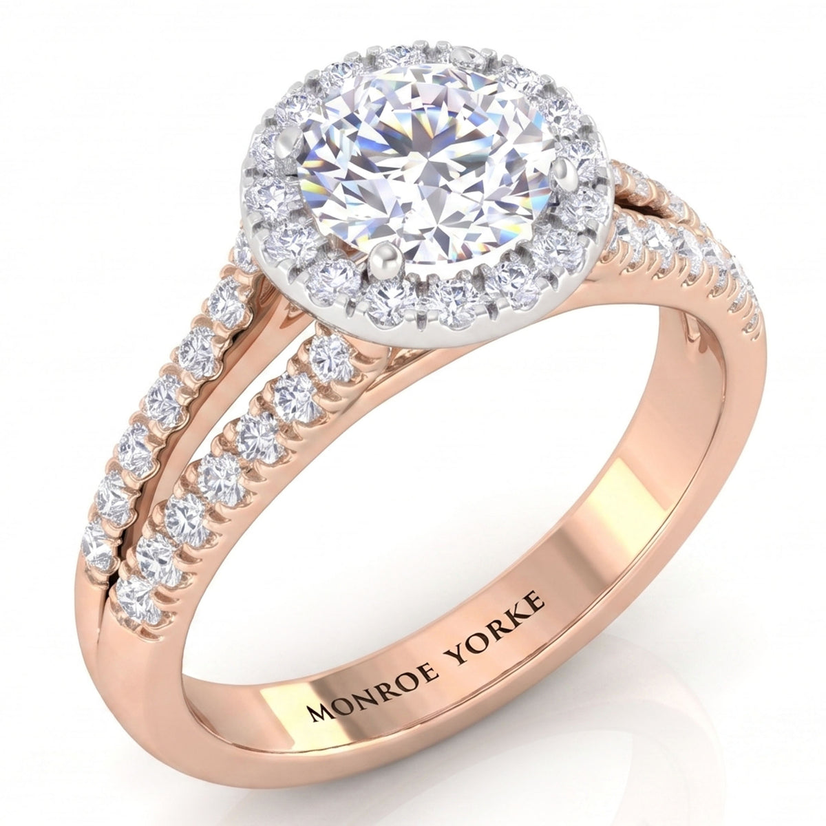 A rose gold halo engagement ring with a round-cut centre stone and smaller accent stones along the split shank, shown on a clean white background. 