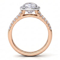A rose gold engagement ring featuring a round-cut diamond centre stone in a scalloped halo, with small pavé diamonds along the shank, shown on a clean white background.