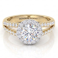 A yellow gold halo ring with a round-cut centre stone and pavé diamond set split band, 