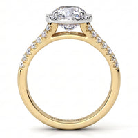 A yellow gold ring with a round-cut diamond centre stone and small pavé diamonds along the shoulders, set against a plain white background.