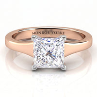 Chester -  princess-cut diamond engagement ring in a rose gold band with 'MONROE YORKE' engraved inside the band, shown on a reflective white surface.