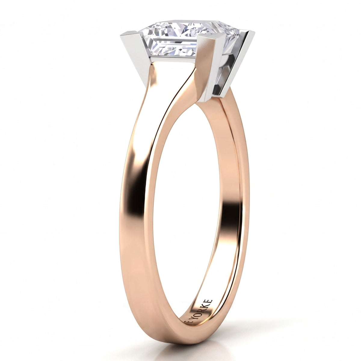 Chester rose gold solitaire engagement ring, angled view of the princess cut centre diamond in a V claw setting on a plain tapered band.