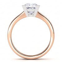 Chester rose gold solitaire engagement ring, side view of the princess cut centre diamond in a V claw setting above a plain tapered band.