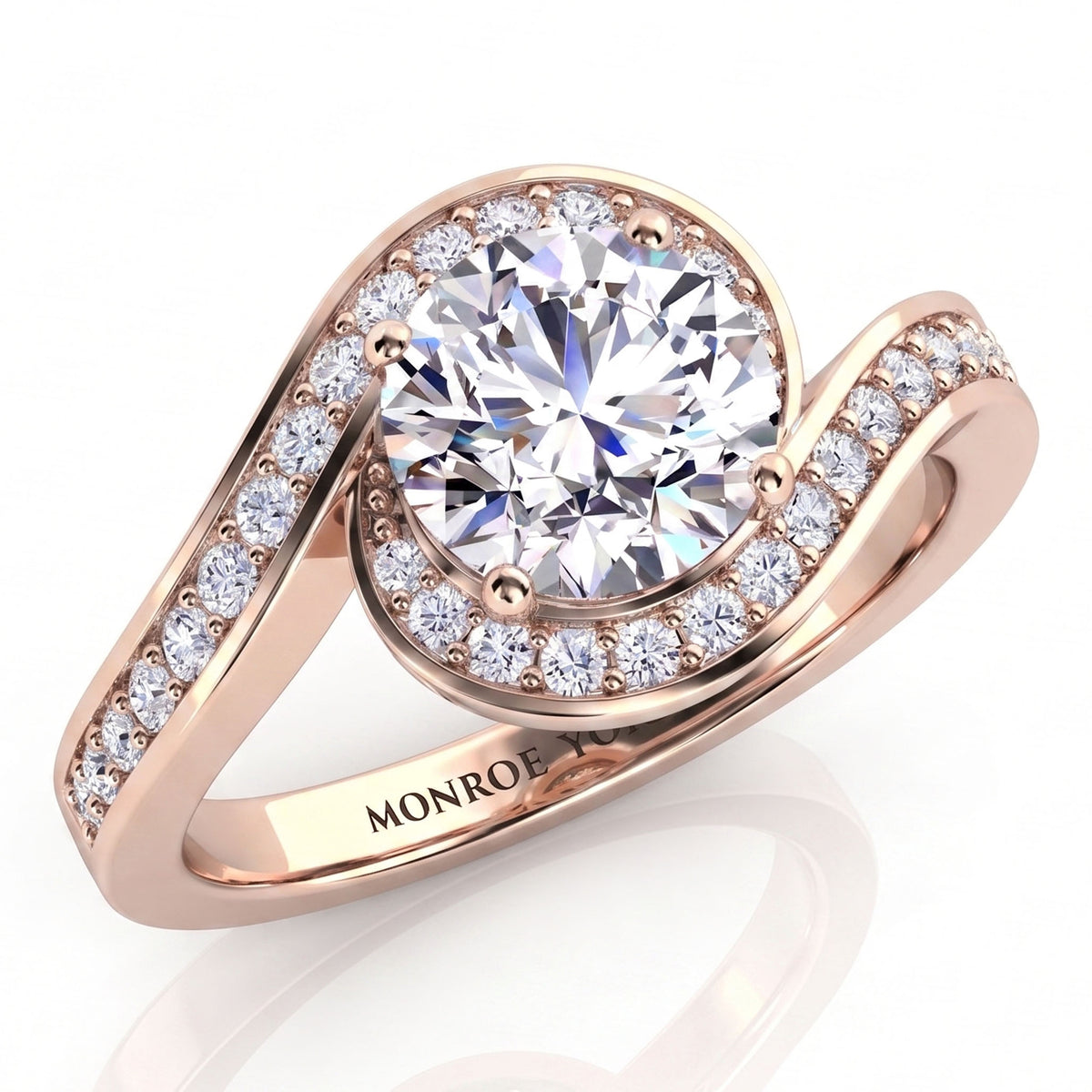 Clementine rose gold engagement ring, round centre diamond with the micro claw set band wrapping around it.
