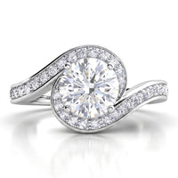 Clementine unique halo engagement ring in white gold or platinum, round centre diamond encircled by the diamond set band.