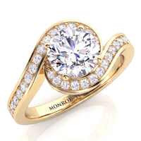 Clementine yellow gold engagement ring, round brilliant centre diamond with the diamond set band wrapping around it.