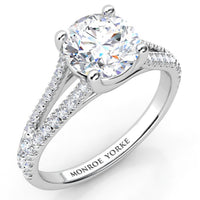 Cora split band engagement ring in white gold or platinum, round centre diamond in a crossover four claw setting.