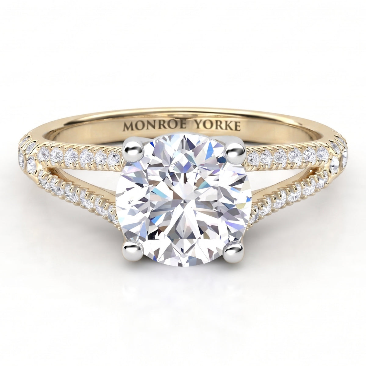 A yellow gold split band diamond engagement ring with a round brilliant-cut center stone and pavé-set accent stones along the split shank, engraved with 'MONROE YORKE' on the inside band, shown on a white background.