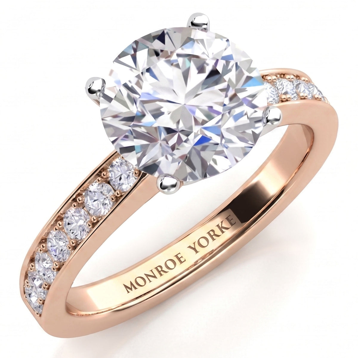 Danae engagement ring in rose gold. Round brilliant centre diamond in a four claw setting with pave-set shoulder diamonds.