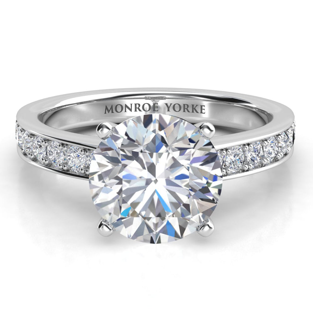 Danae engagement ring in white gold or platinum, showing the pave diamonds sweeping up the band to meet the centre setting.