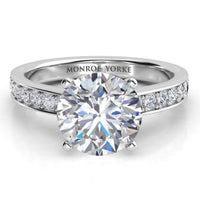 Danae engagement ring in white gold or platinum, showing the pave diamonds sweeping up the band to meet the centre setting.