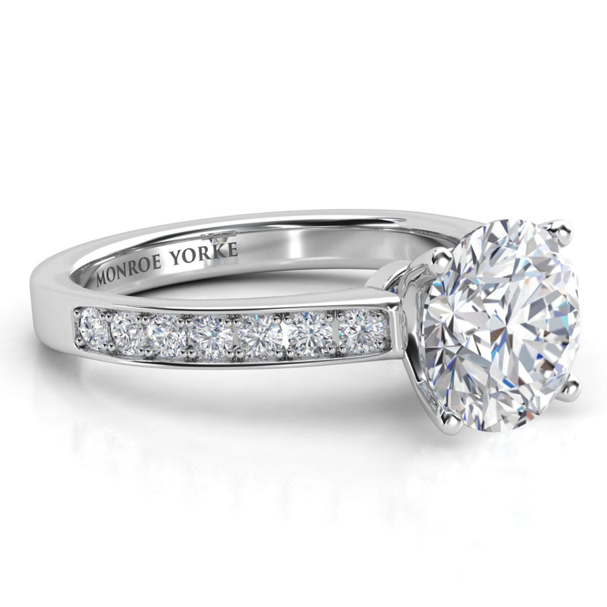 Danae engagement ring in white gold or platinum. Round brilliant centre diamond above a pave-set band.