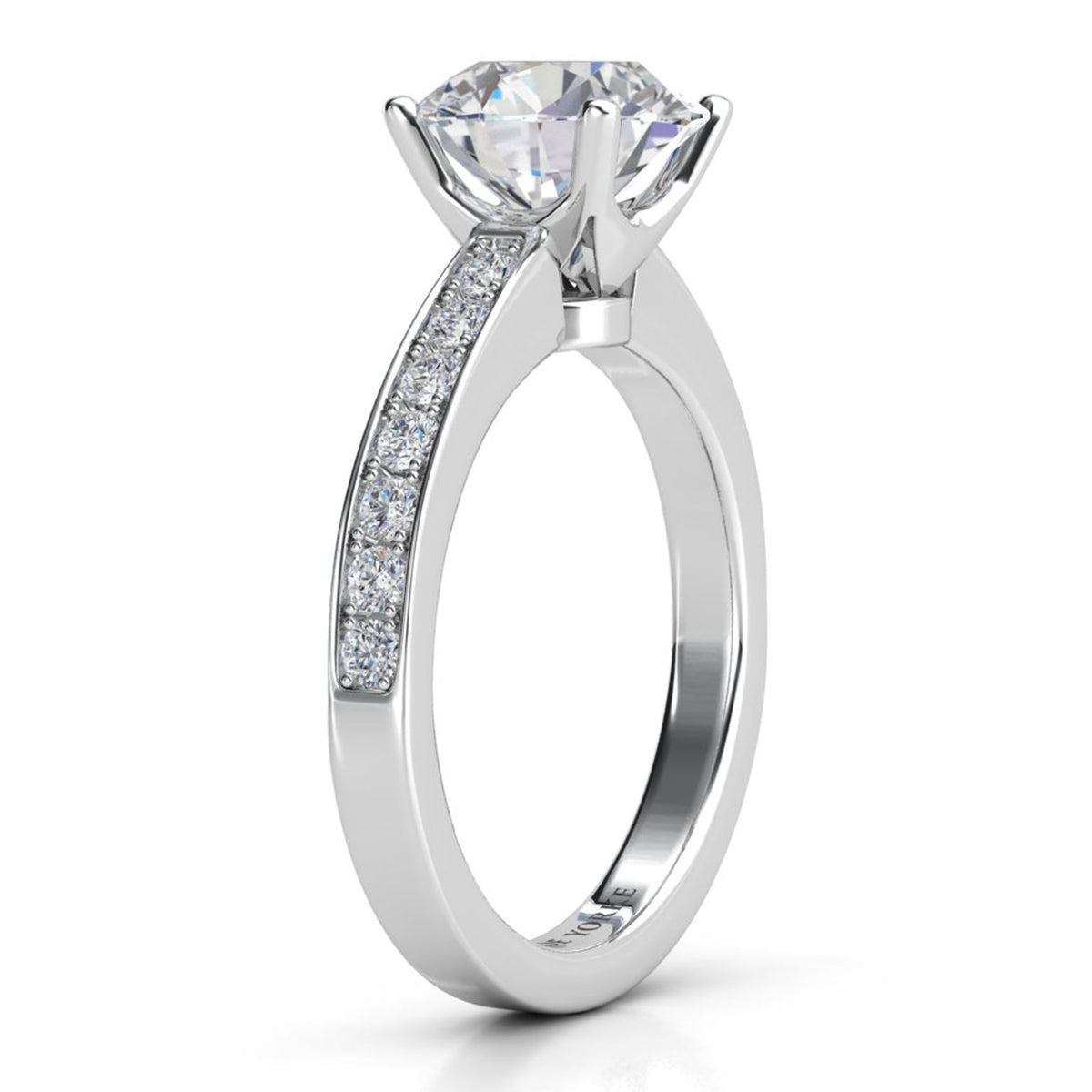 Danae engagement ring in white gold or platinum. Side view showing the four claw centre setting and pave-set shoulders.
