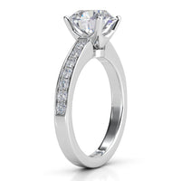 Danae engagement ring in white gold or platinum. Side view showing the four claw centre setting and pave-set shoulders.