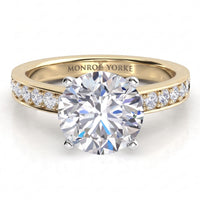 Danae engagement ring in yellow gold, showing the pave diamonds along the shoulders and the engraved inner band.