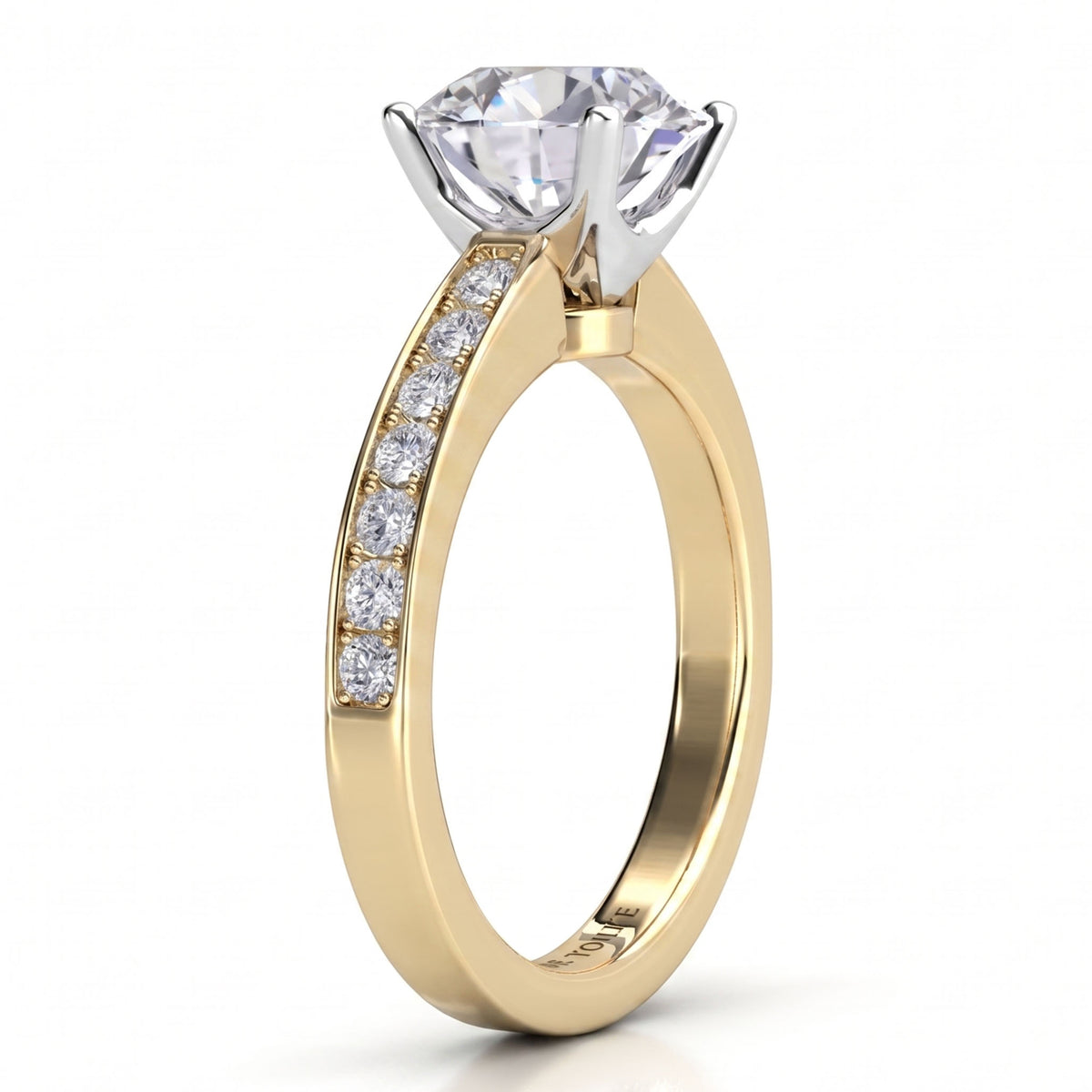 Danae engagement ring in yellow gold. Side view showing the four claw centre setting and the pave-set shoulders.
