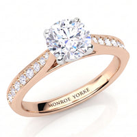 Denver rose gold engagement ring, round brilliant centre diamond and a tapered diamond set band.