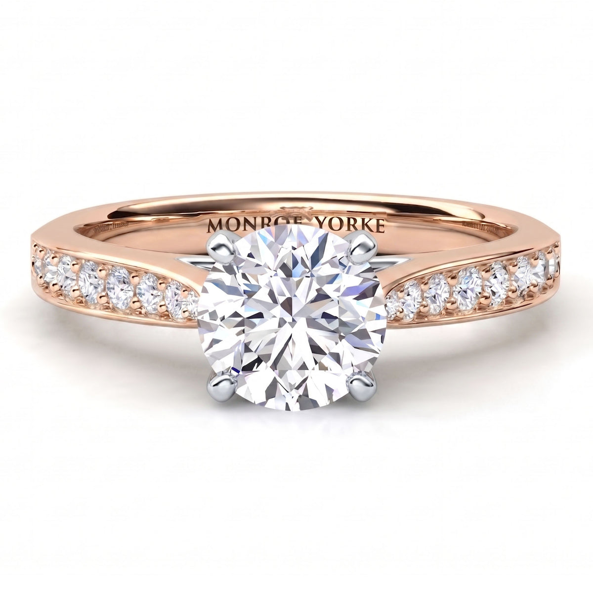 Denver rose gold engagement ring, round brilliant centre diamond in a four claw head with micro claw set diamonds on the band.