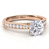 Denver rose gold engagement ring, round brilliant centre diamond with diamonds running along the band.