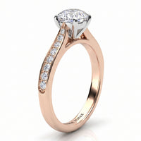 Denver rose gold engagement ring, round brilliant centre diamond above a tapered band set with small round diamonds.
