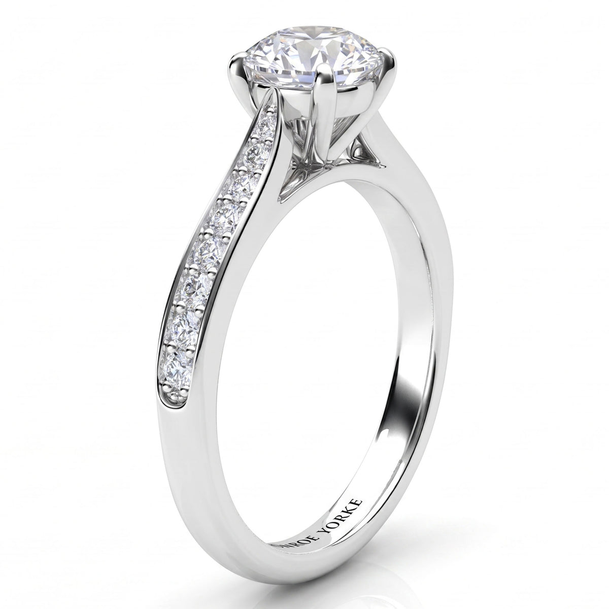 Denver engagement ring in white gold or platinum, side view of the diamond set band tapering into the four claw centre setting.
