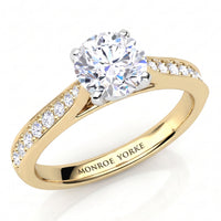 Denver yellow gold engagement ring, round brilliant centre diamond and a tapered diamond set band, Monroe Yorke engraved inside the band.