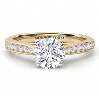 Denver yellow gold engagement ring, round brilliant centre diamond in a four claw head with micro claw set diamonds along the shoulders.