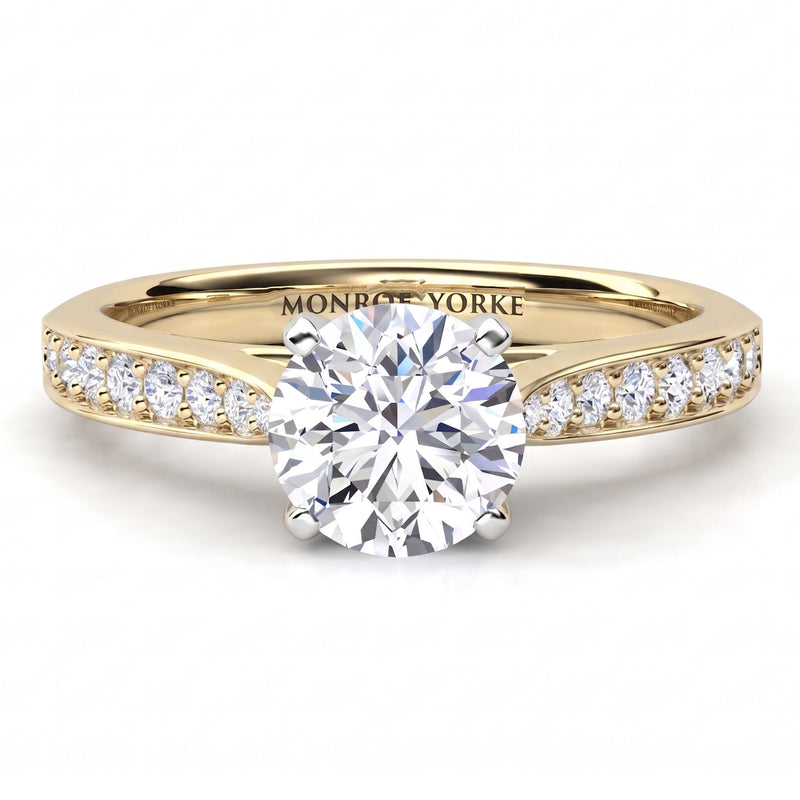 Denver yellow gold engagement ring, round brilliant centre diamond in a four claw head with micro claw set diamonds along the shoulders.