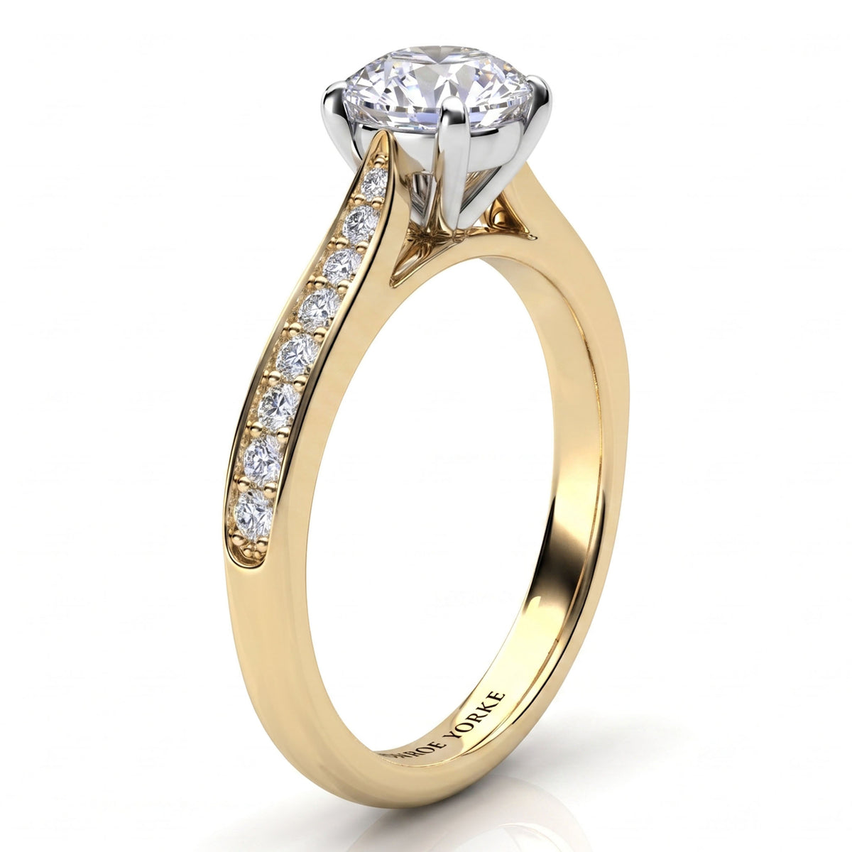 Denver yellow gold engagement ring, side view of the round brilliant centre diamond and the tapered diamond set band.