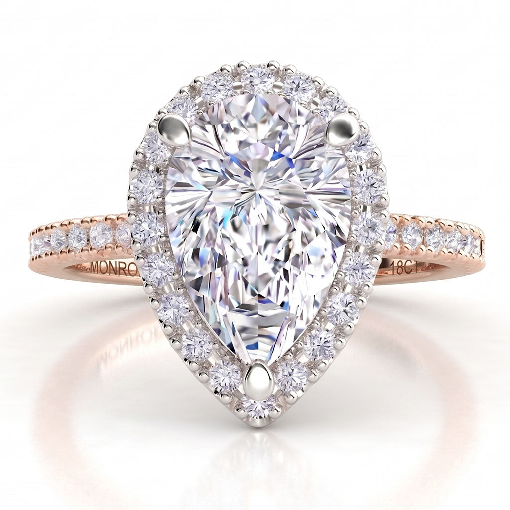 Dune in 18ct rose gold, angled view showing the halo around the pear centre