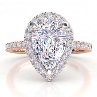 Dune in 18ct rose gold, angled view showing the halo around the pear centre