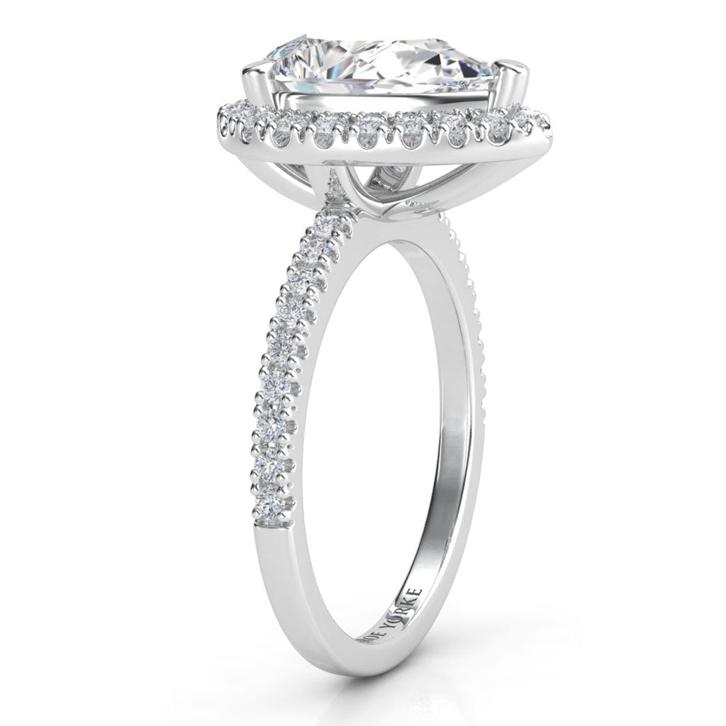 Dune pear cut diamond halo ring. Side view showing beautiful centre diamond halo setting and diamond set band.  18ct white gold  and platinum