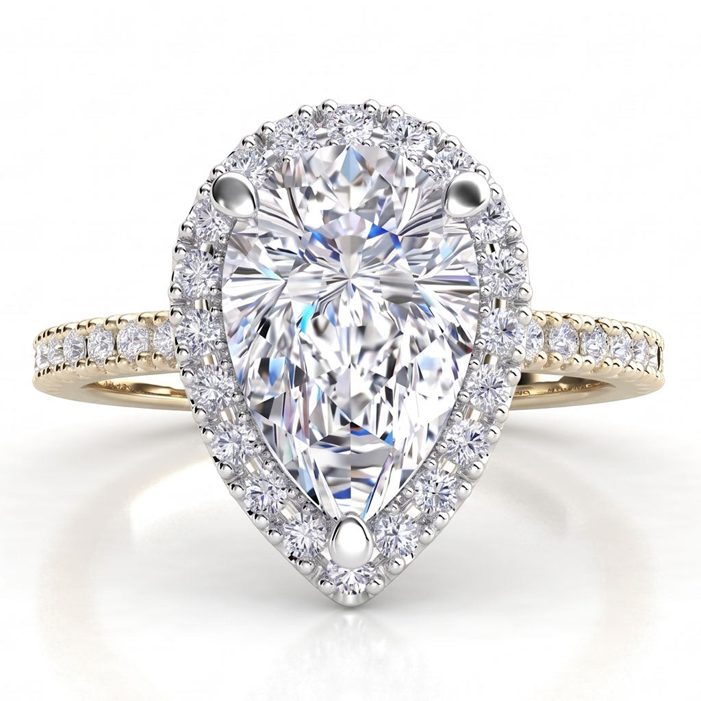 Dune in 18ct yellow gold, angled view showing the halo around the pear centre