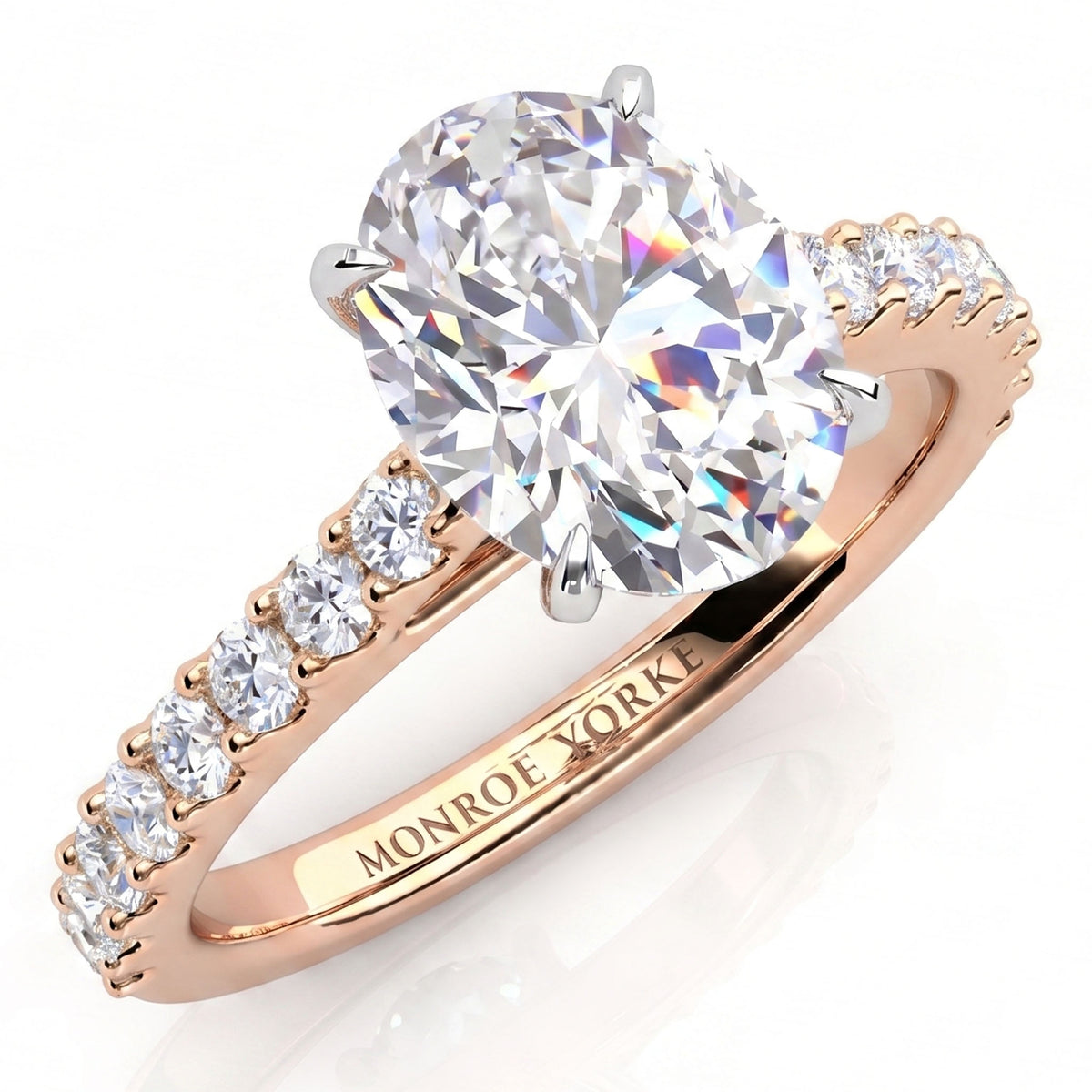 Elodie - Rose gold engagement ring with a large oval-cut center stone and small pavé-set round stones on the band, 